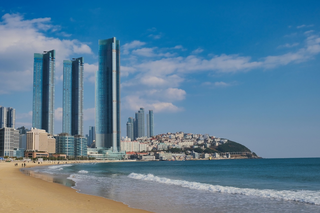 Modern Busan cityscape with skyscrapers along the beach coastline