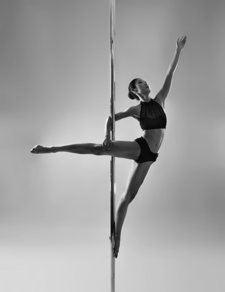 Artistic pole dancer performing